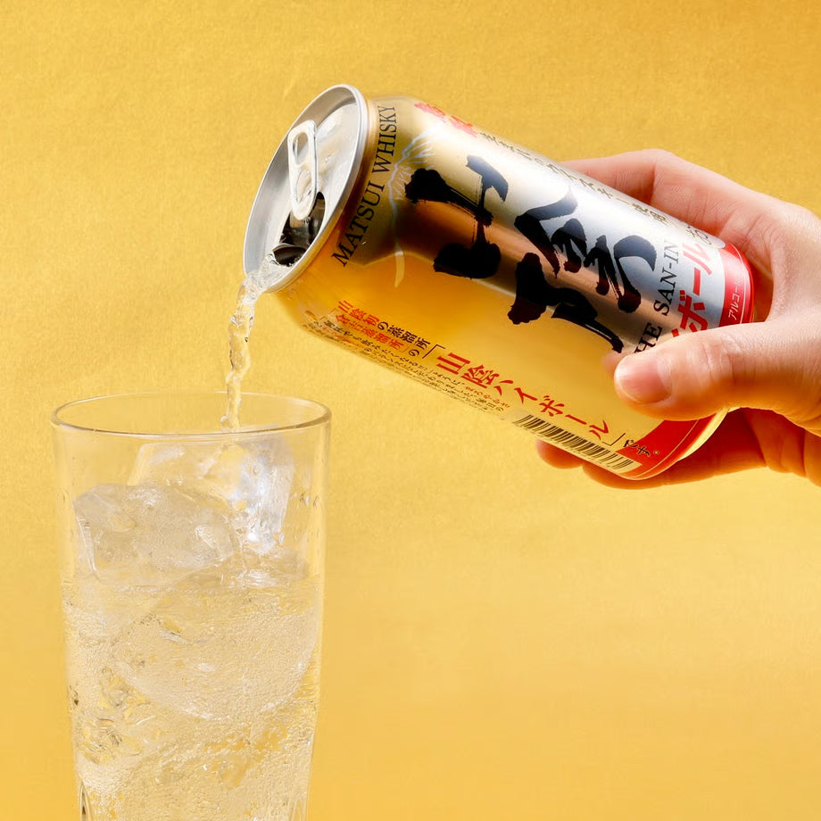 山陰ハイボール缶をグラスに注いでいる様子。鳥取生まれのウイスキーを使ったハイボールが、氷の入ったグラスに注がれているシーン。